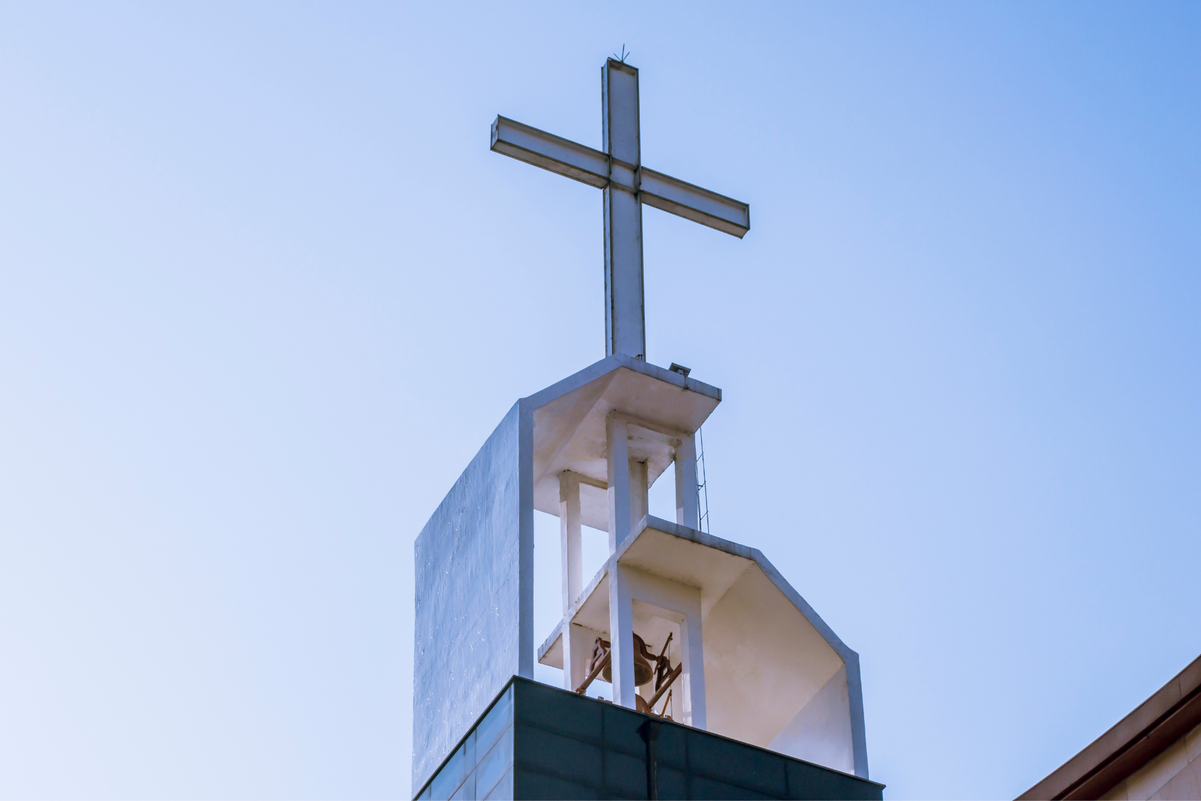 Wooden cross against a blue sky