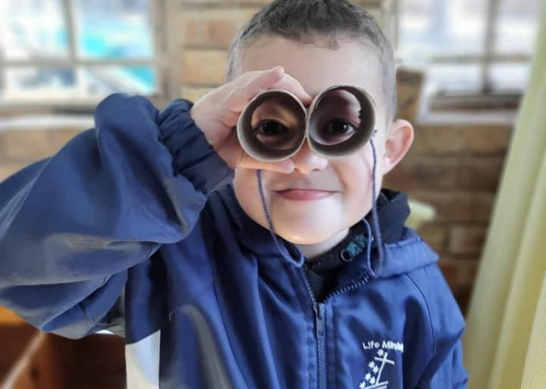 School child wearing safety glasses